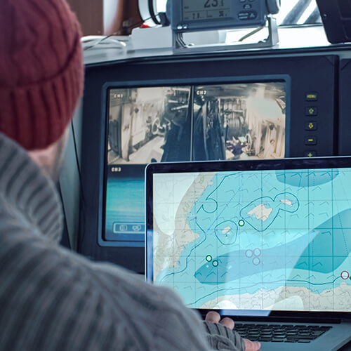 commercial fisherman surrounded by monitors